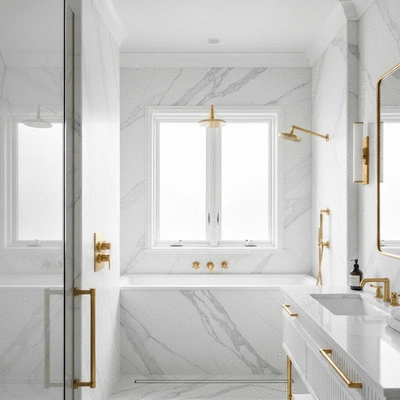 Modern luxury bathroom with marble tiles and gold fixtures
